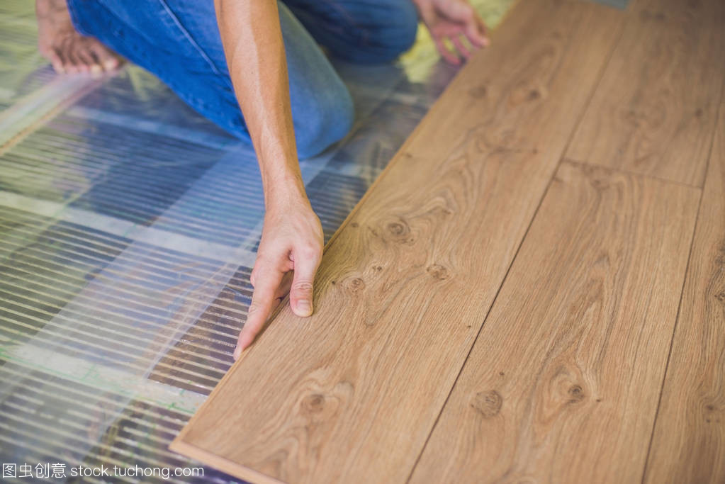 Man installing new laminate flooring